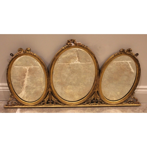 877 - A 19th century giltwood and gesso ‘overmantel’ mirror, designed as three oval bevelled mirror plates... 