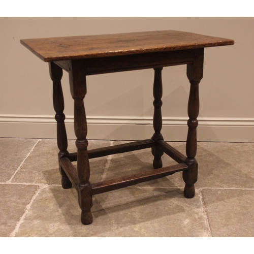 906 - An early 18th century jointed oak rectangular occasional table, the three plank top upon twin balust... 