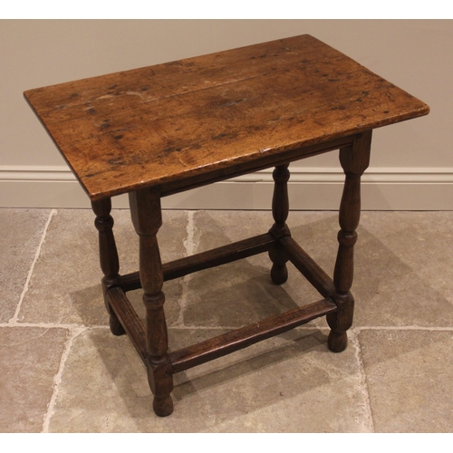 906 - An early 18th century jointed oak rectangular occasional table, the three plank top upon twin balust... 