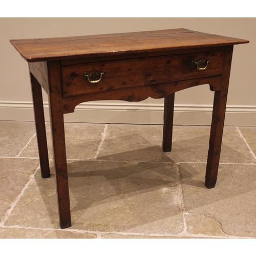 929 - A George III vernacular fruitwood side table, the four plank oversailing top above a single pine lin... 