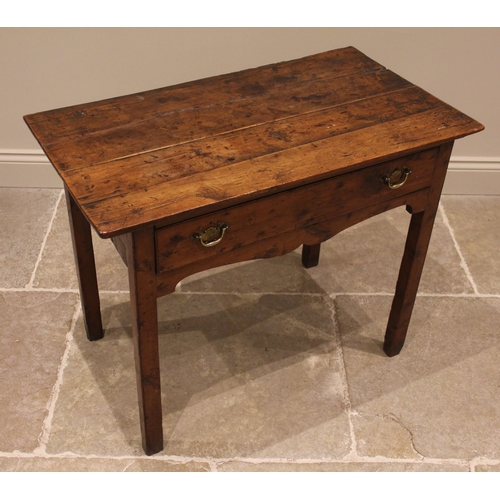 929 - A George III vernacular fruitwood side table, the four plank oversailing top above a single pine lin... 