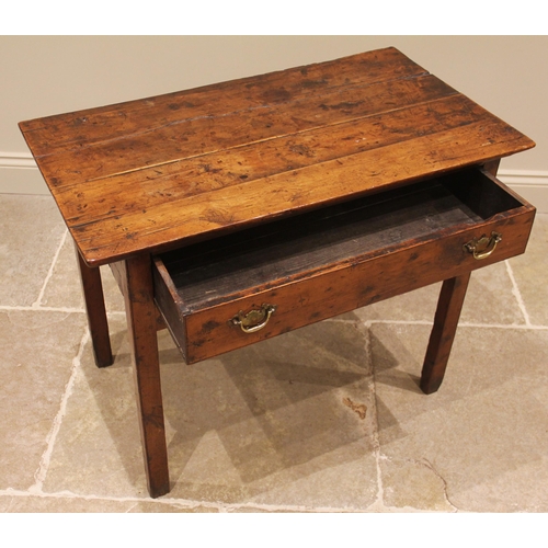 929 - A George III vernacular fruitwood side table, the four plank oversailing top above a single pine lin... 