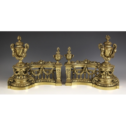 953 - A pair of French brass fireside chenets, 20th century, each decorated with foliate swags and floral ... 