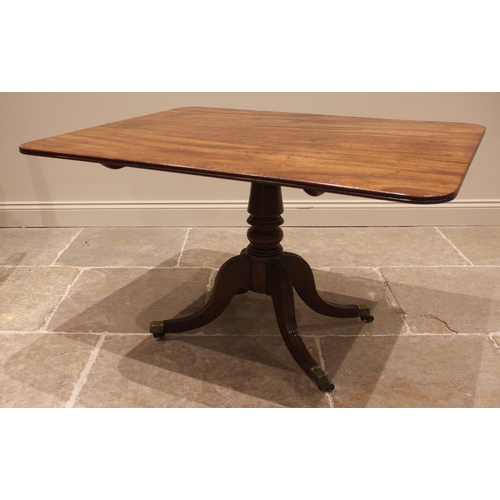 975 - A mahogany breakfast table, 19th century, the rectangular top with rounded corners upon four channel... 