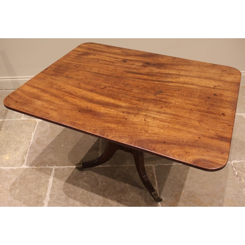 975 - A mahogany breakfast table, 19th century, the rectangular top with rounded corners upon four channel... 