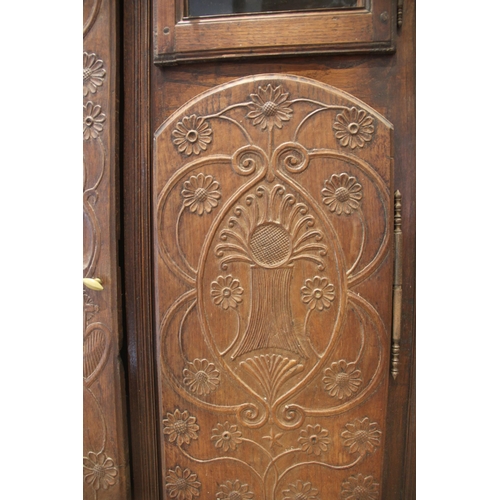 989 - A French elm and fruit wood armoire/cupboard, 19th century, the oversailing cornice above a full len... 