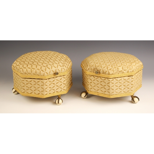 967 - A pair of Victorian upholstered octagonal footstools, with hinged covers, upon three brass claw and ... 