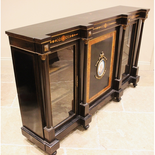 1014 - A Victorian ebonised and walnut banded credenza, the central cupboard door inset with an oval French... 