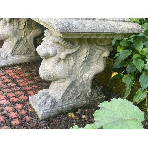 860 - A Haddonstone curved garden bench, on three pedestals, 150cm wide