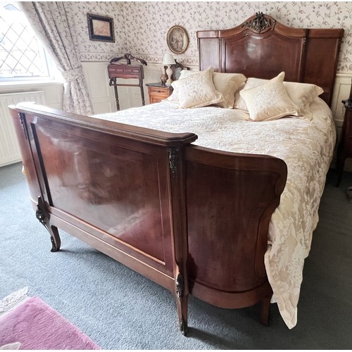 950 - A French Louis XV style walnut double bed, early to mid 20th century, the break arch headboard appli... 