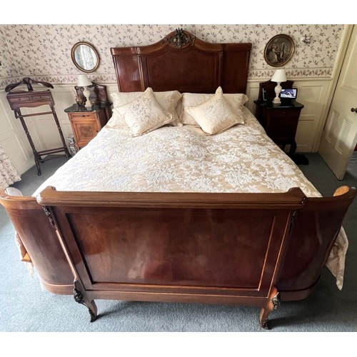 950 - A French Louis XV style walnut double bed, early to mid 20th century, the break arch headboard appli... 