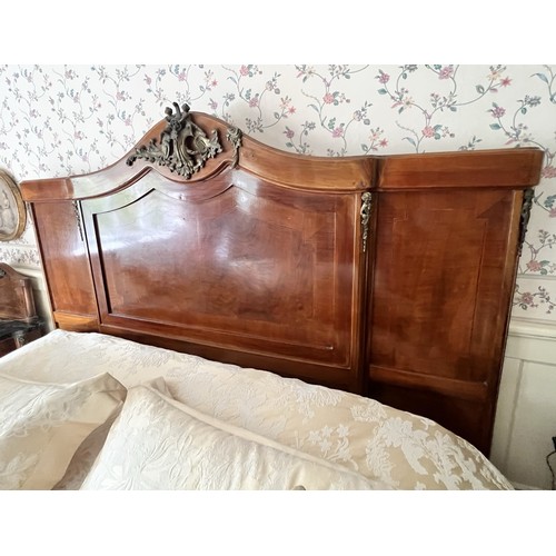 950 - A French Louis XV style walnut double bed, early to mid 20th century, the break arch headboard appli... 