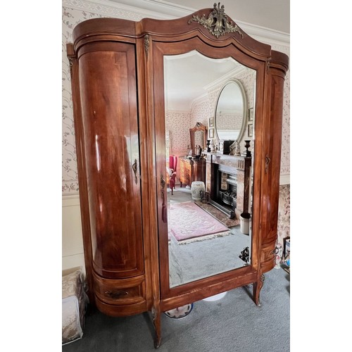 951 - A French Louis XV style walnut triple wardrobe, early to mid 20th century, the cornice of break arch... 