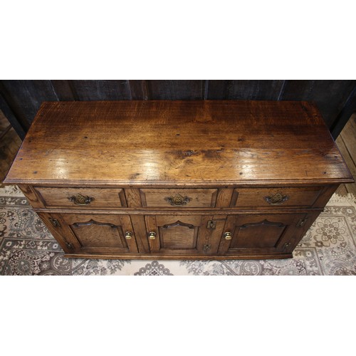 961 - A George III style oak dresser base, late 20th century, in the manner of Titchmarsh and Goodwin, the... 