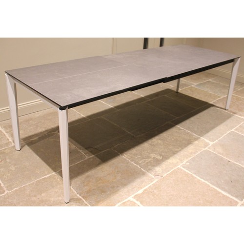 1079 - An Italian glass top 'rocker' table, early 21st century, the slate effect rectangular glass top upon... 