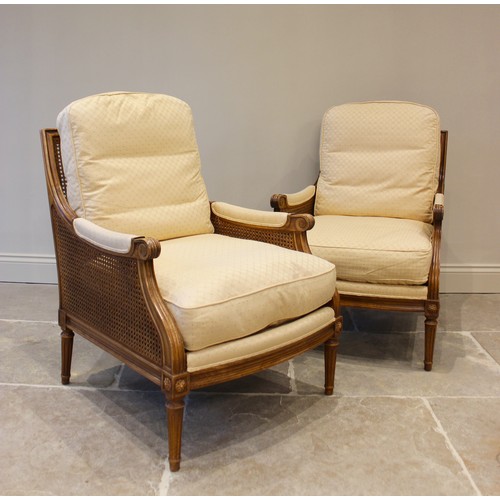 1025 - A pair of Empire style stained beechwood bergère armchairs, late 20th century, each with bespoke cus... 