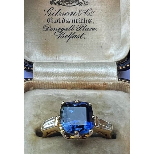 309 - An 18ct yellow gold certified sapphire and diamond three stone ring, the cushion cut sapphire (certi... 