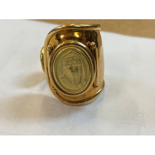 168 - A yellow metal dress ring, the tapered open ring with applied oval pad depicting lady, ring size N, ... 