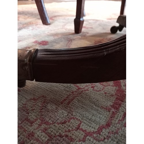 975 - A mahogany breakfast table, 19th century, the rectangular top with rounded corners upon four channel... 