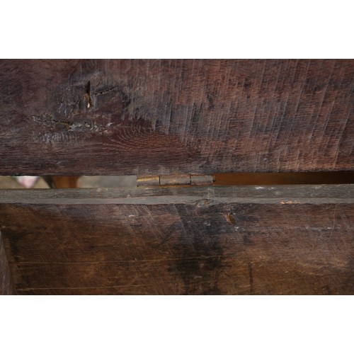 905 - A 17th century carved oak six plank coffer, the hinged cover carved with geometric motifs within a g... 