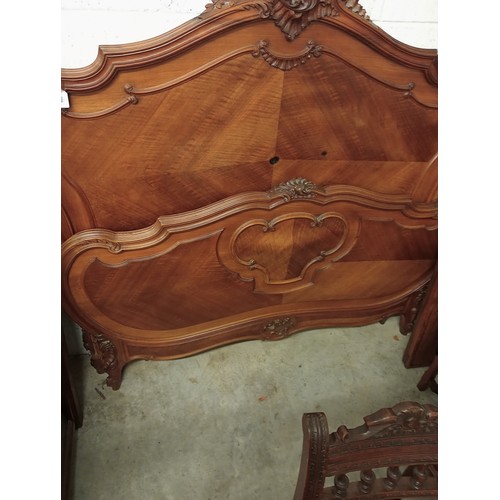 988 - A French walnut bed, late 19th/early 20th century, the shaped headboard with a carved shell and foli... 