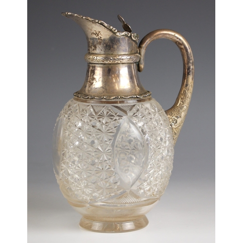 1 - An Edwardian silver mounted claret jug, Walker and Hall, Sheffield 1905, the trefoil shaped thumbpie... 