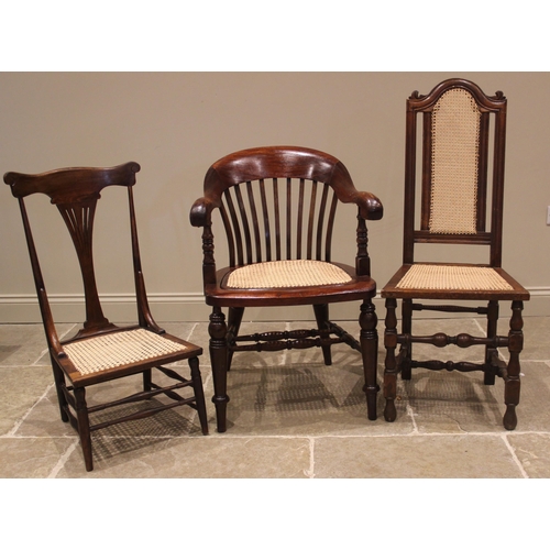 1004 - A Victorian stained wood smokers bow elbow chair, with a lath back and cane work seat, upon ring tur... 