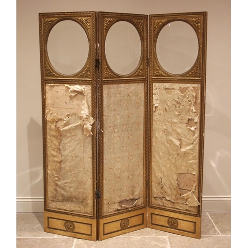 1008 - A Victorian giltwood and gesso silkwork three panel dressing screen, each panel with a circular beve... 