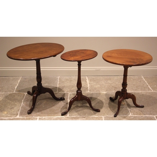 1026 - A 19th century mahogany tripod table, the oval tilt top upon a gun barrel column and three cabriole ... 