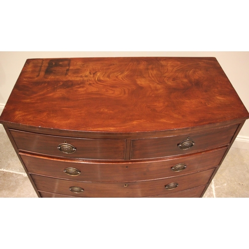 1027 - An early 19th century mahogany bowfront chest of drawers, the figured top above an arrangement of tw... 