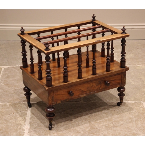 1034 - A Victorian walnut Canterbury, the spindled dividers and three compartments over a single frieze dra... 