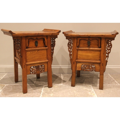 1048 - A near pair of Chinese influence elm bedside/lamp tables, early 20th century, each with an oversaili... 