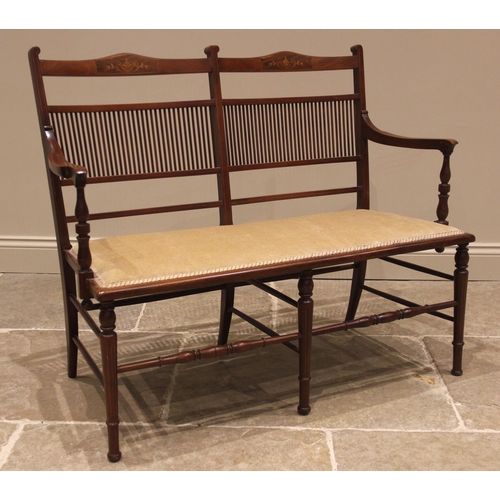 1050 - An Edwardian mahogany twin seat chair sofa, with a double comb and rail back inlaid with urn and fol... 