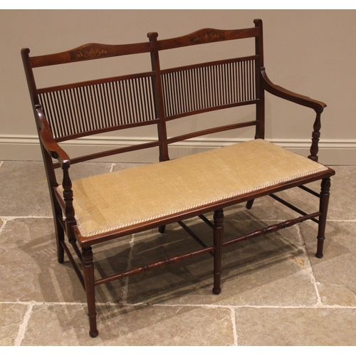 1050 - An Edwardian mahogany twin seat chair sofa, with a double comb and rail back inlaid with urn and fol... 