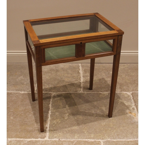 1051 - An Edwardian mahogany bijouterie table, opening to a lined interior, outlined with boxwood stringing... 