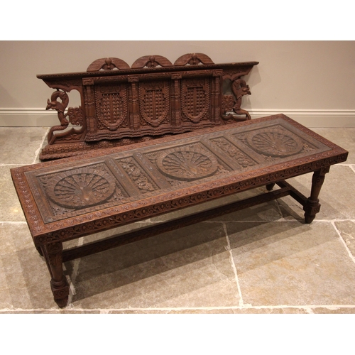 1066 - A Nepalese carved hardwood coffee table, late 20th century, the rectangular top with three relief ca... 