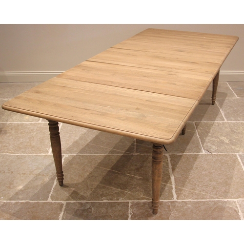 1073 - An Oka 'Charlotte' extending dining table, constructed from alder wood with a weathered oak finish, ... 