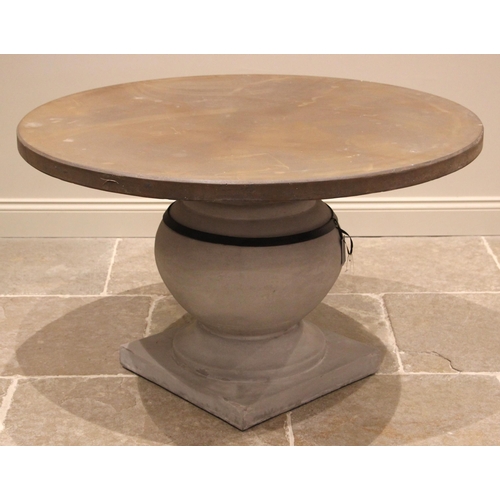 1075 - An Oka 'Callanish' stone and resin pedestal patio/conservatory dining table, the circular table top ... 