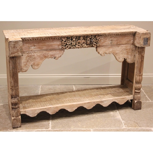 1076 - An Indian limed hardwood console table, late 20th/early 21st century, the plank top above a frieze c... 