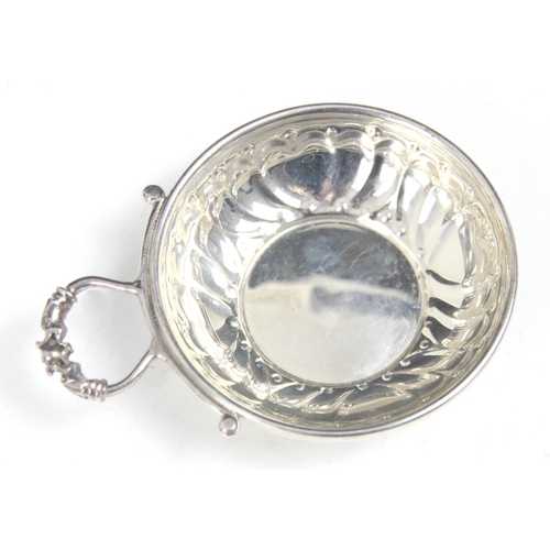 110 - A silver tasse du vin, 'P&S' Birmingham 1993, of typical circular form with heart embossed detail to... 