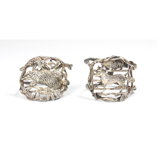 111 - A set of two silver coloured napkin rings, possibly Dutch, the openwork circular rings with stylised... 