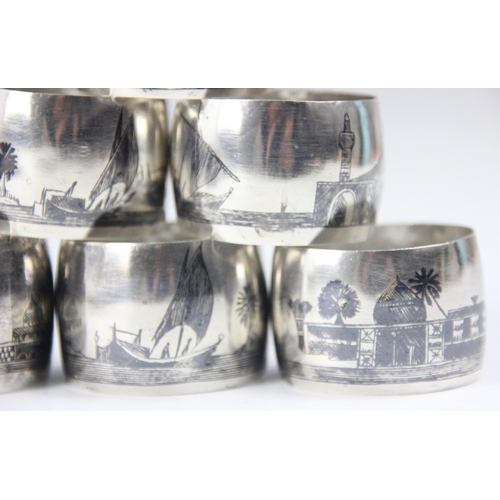 123 - A group of six silver niello coloured napkin rings, possibly Iraqi, the convex circular napkin rings... 