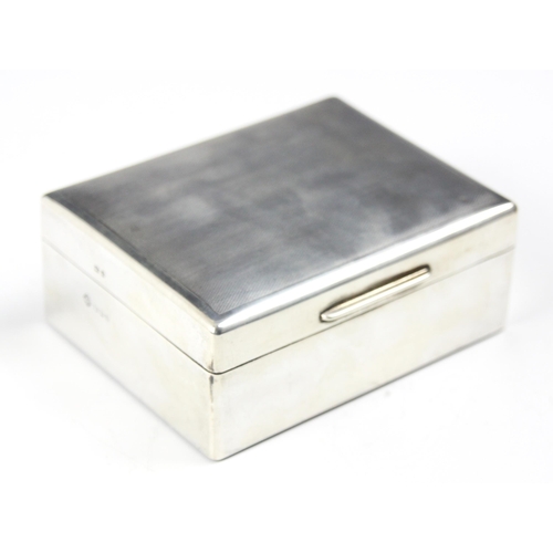 126 - A silver mounted cigarette box, Asprey & Co Ltd, London 1959, the engine turned hinged cover opening... 