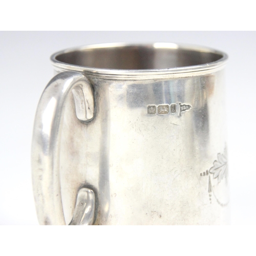 133 - An Edwardian silver christening mug, Walker and Hall, Sheffield 1903, the loop handle above a tapere... 