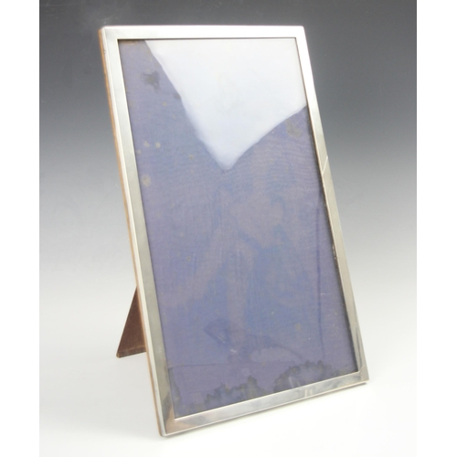 156 - A George V silver mounted photograph frame, A & J Zimmerman Ltd, Birmingham 1927, of large proportio... 