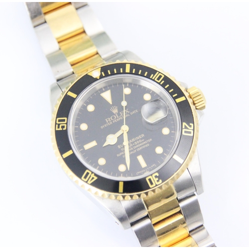 199 - A Rolex Submariner Oyster perpetual date bi-colour wristwatch, the circular black dial with baton an... 