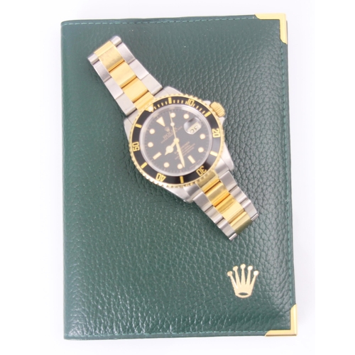 199 - A Rolex Submariner Oyster perpetual date bi-colour wristwatch, the circular black dial with baton an... 