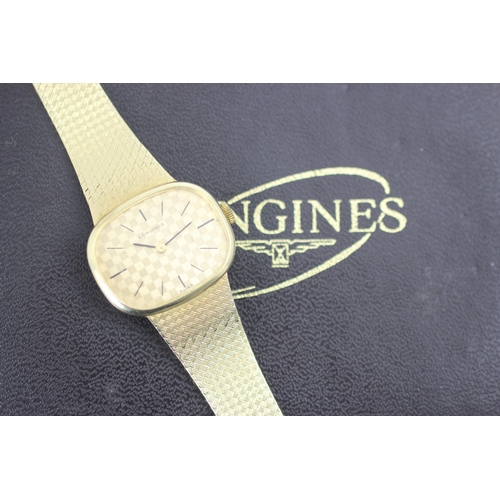 202 - A Longines 9ct yellow gold watch, the round rectangular dial with 'chess board' style design, set to... 