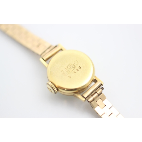 207 - A yellow metal Bucherer ladies wrist watch, the circular white dial with baton markers, set to plain... 