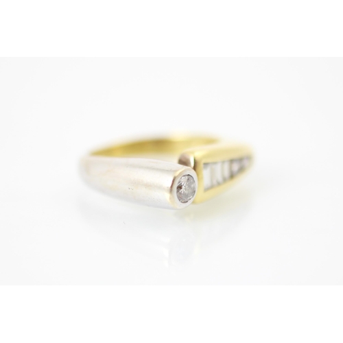 211 - A yellow and white metal diamond set dress ring, the round cut diamond set within white metal rub ov... 